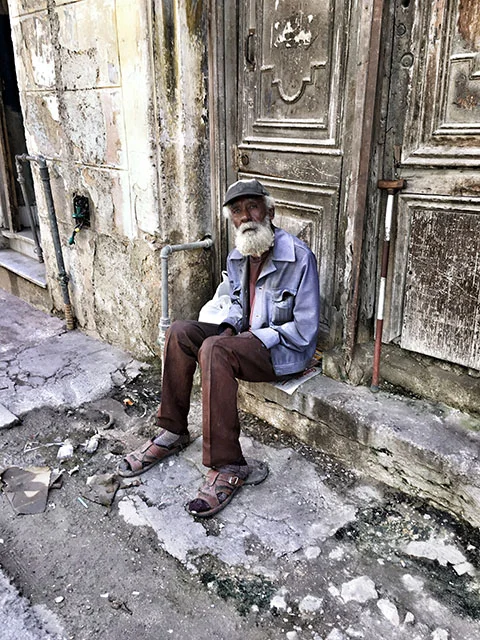 Guy on Stoop Reduced.jpg