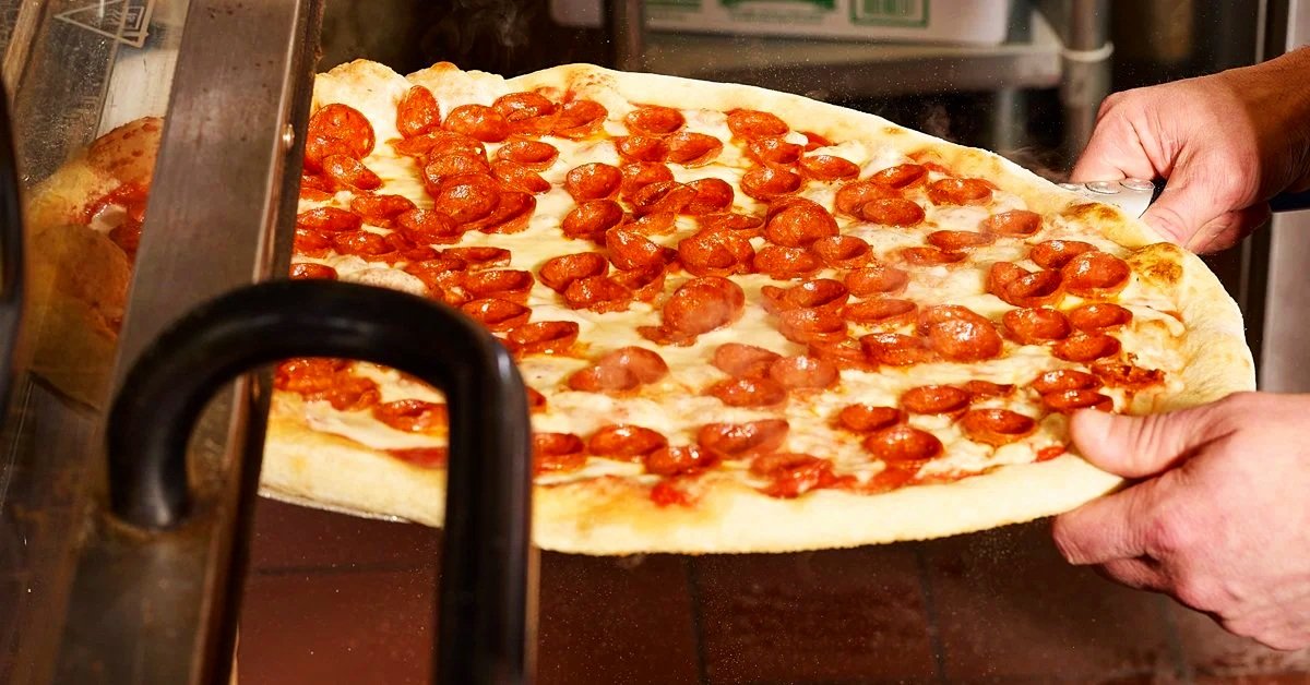 Pulling a Pepperoni Pizza out of the Pizza Oven.jpg