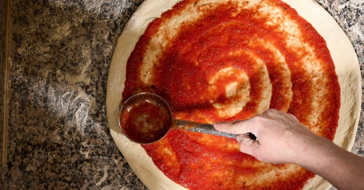 Spreading Sauce on Pizza Dough.jpg