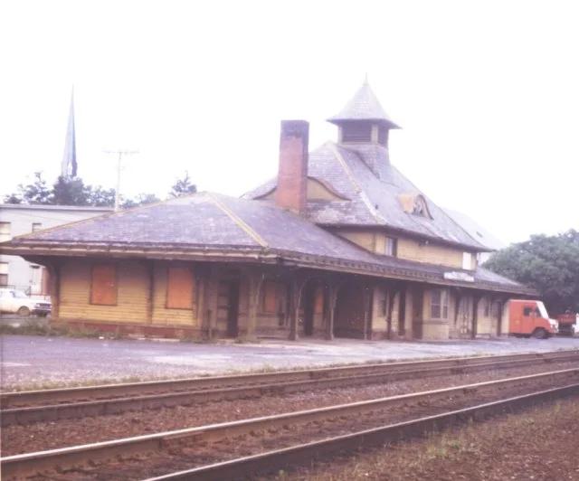 Station at Cobleskill, about 1970. While the station is decidedly run down, the tracks look well cared for and shiny. View is looking at the west (railroad south) end.