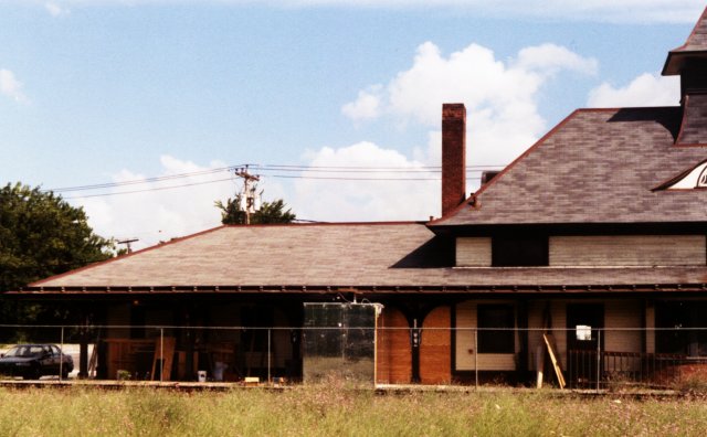 The track side of the west end of the station, summer of 1998. Notice the construction materials lying about. The station was being renovated for use as a restaurant in the freight house (west) end, and a bar in the waiting room (east) end.