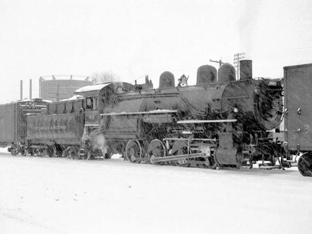 D&H 83 TYPE: 0-8-0 CLASS: B-5 DATE: 1/1/48 LOCATION: Oneonta, NY NOTES: Switching in snow storm opposite passenger station. Rebuilt from 2-8-0 E-4 #1002 in April, 1923, sold to Luria in March, 1950. PHOTOGRAPHER: Jim Wright