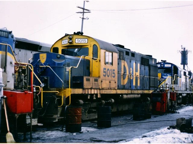 D&H 5015 Delaware & Hudson RS36's #5015 sporting the experimental paint scheme never adopted. Fred Cheney, Chief Mechanical Officer, Iowa Interstate Railroad (formerly CMO D&H 1979 to 1982) reports "#5015 is alive and well on the Iowa Interstate Railroad as IAIS #900. After a few false starts, it seems to be running well now, assigned lately to the Council Bluffs, Iowa yard." National Railway Equipment in Silvis, Illinois bought D&H RS-11's #5002 and 5009, and RS-36's #5017, 5022, and 5023. Iowa Interstate Railroad was hoping to get the 5023 on the Iowa Interstate, but unfortunately, a change in management precluded any further purchases of the ALCOs. The only one of that group saved was #5017, which went to the Ulster and Delaware. Unfortunately, the rest have been cut up or are in the process of being cut.” Photo by Ronald High, Bob's Photos collection