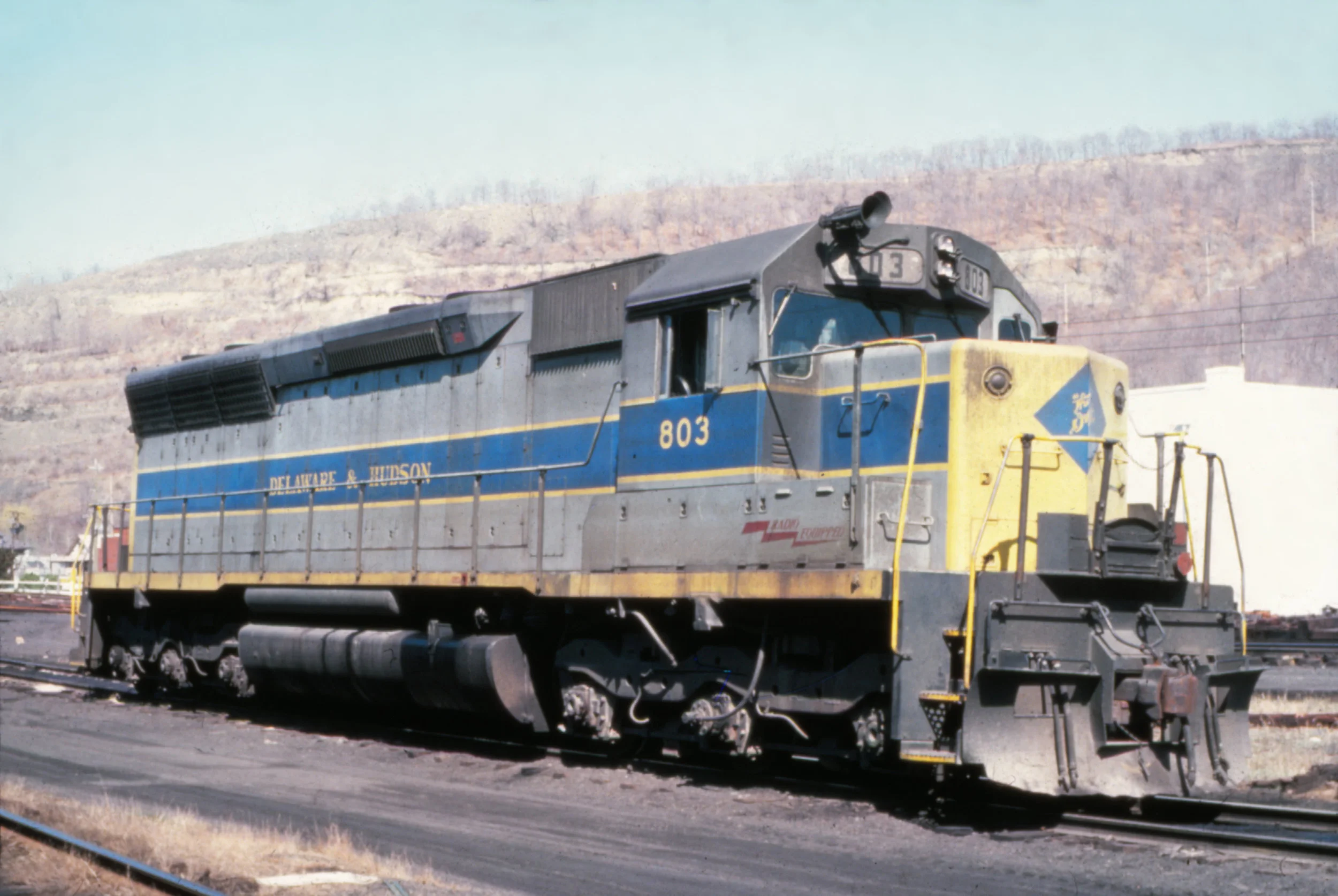 In 1977, D&H SD45 #803 shows off its L-shaped windshield and patched EL paint scheme. The Garbely Publishing Company collection