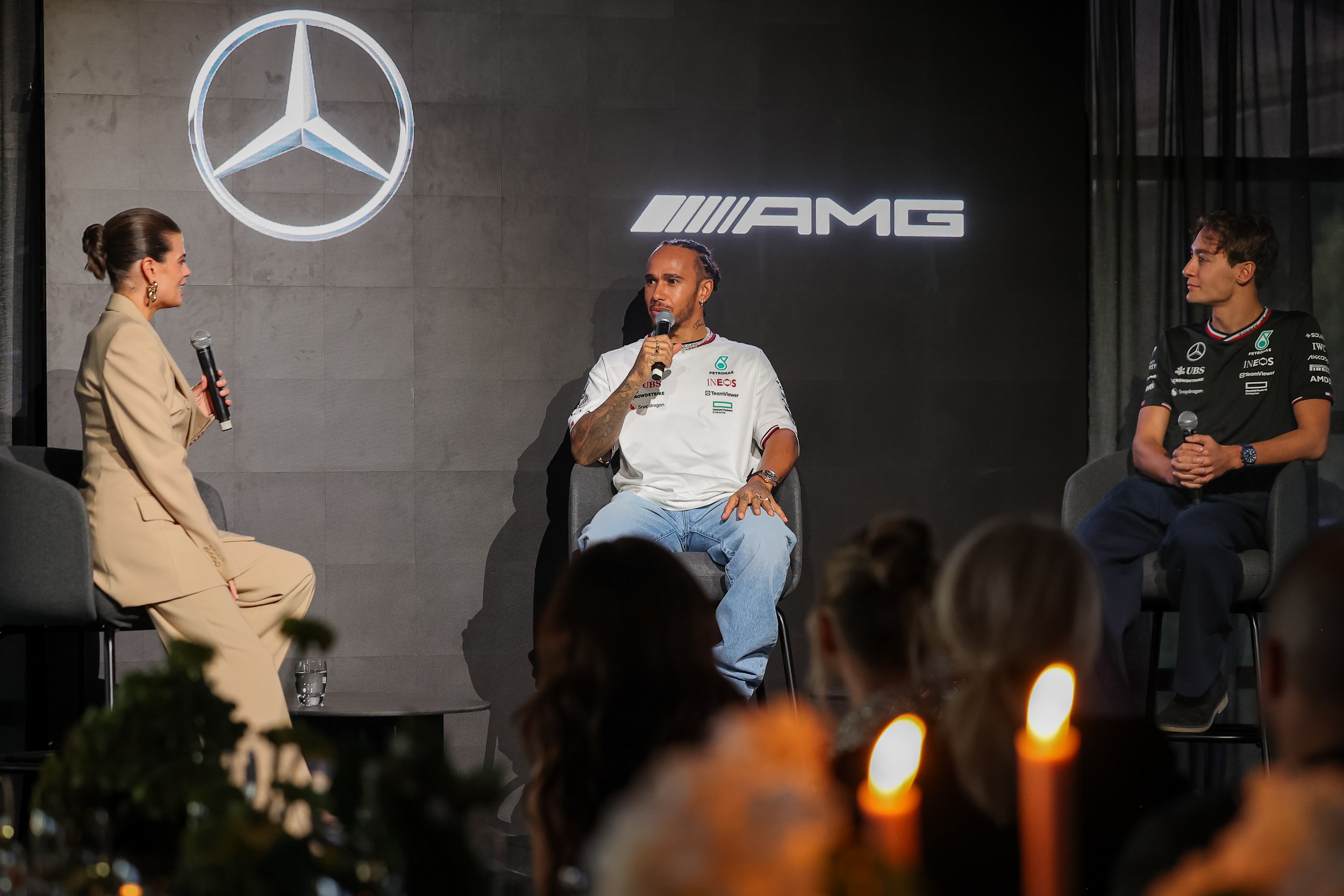 Corporate event photography of a Mercedes-AMG panel discussion featuring formula 1 legend Sir Lewis Hamilton and his teammate George Russell at Greenfields Albert Park during the 2024 Australian Grand Prix
