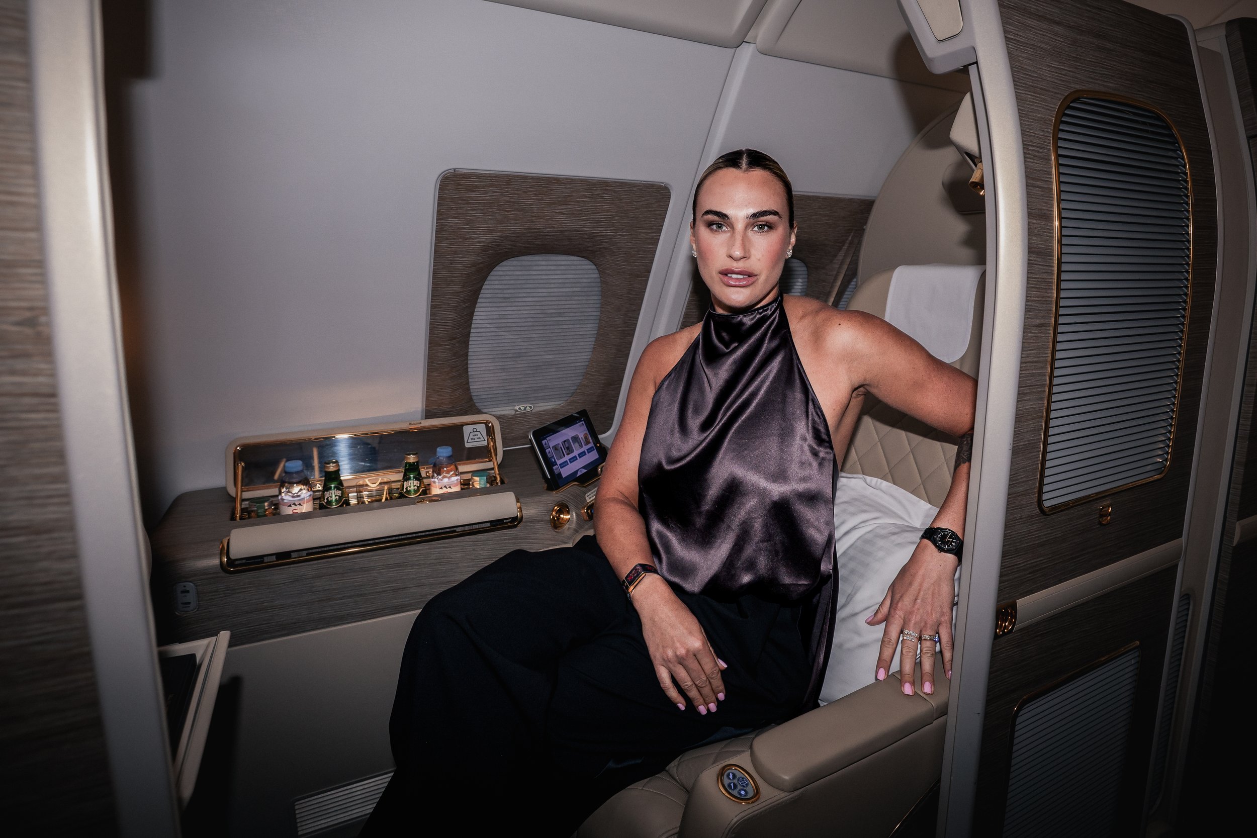 PR and brand photography featuring world tennis number 1 Aryna Sabalenka inside a luxury Emirates A380 First Class cabin at  Melbourne airport
