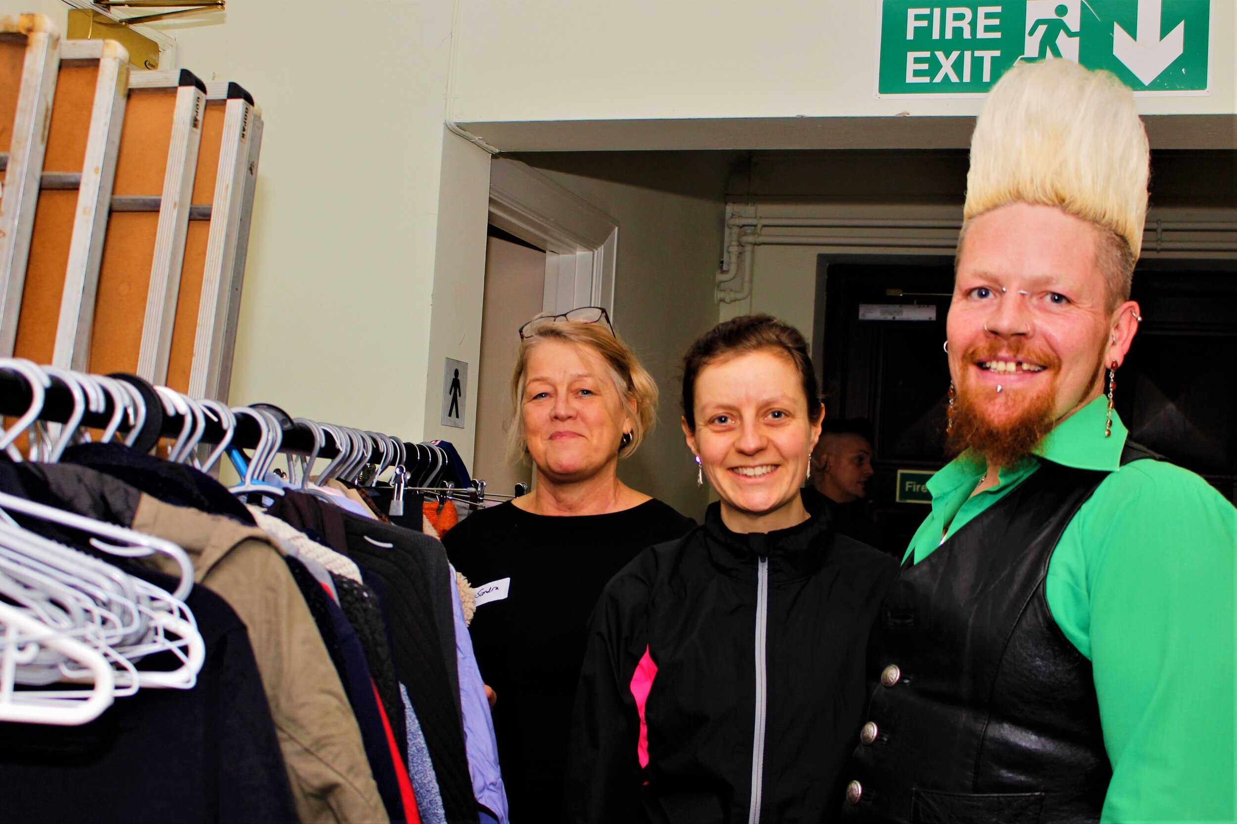 Volunteers of CCS next to donated clothing rail .JPG