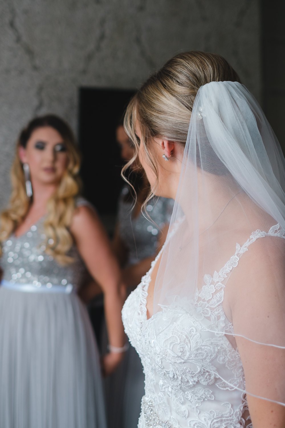 Bride and bridesmaid getting ready