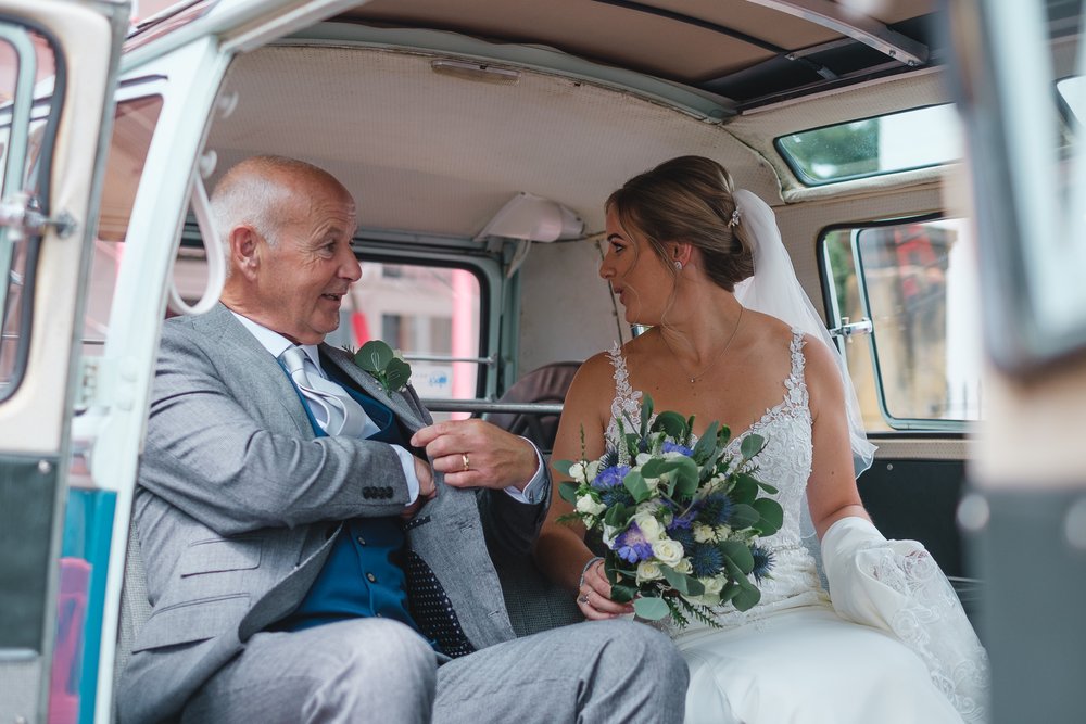 Bride and her father in a VW camber getting ready to head off to the ceremony