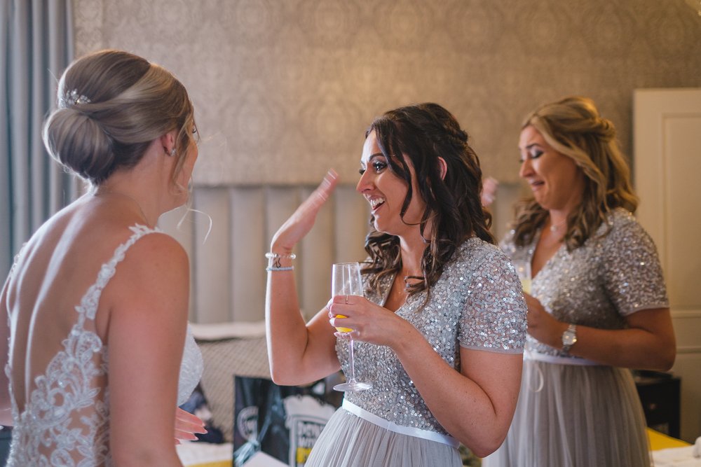 Bridesmaids see the bride in her dress for the first time