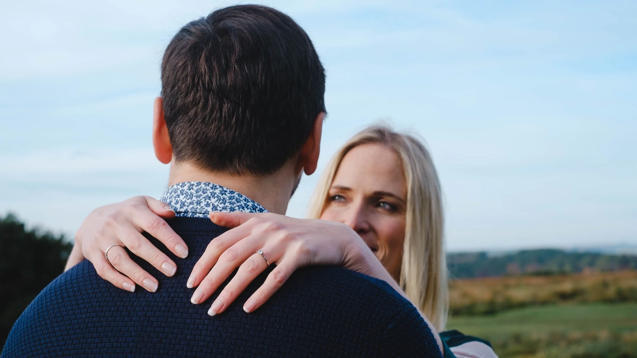 Girl gassing into her fiancée's eyes showing off her engagement ring