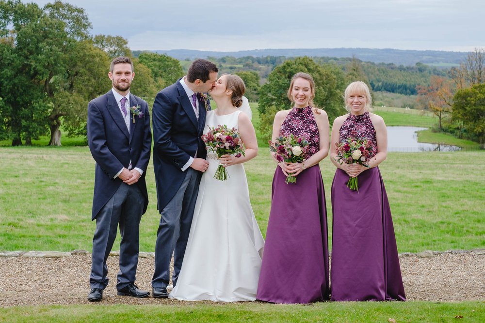 Bridesmaids in jewel purple skirts with a print top