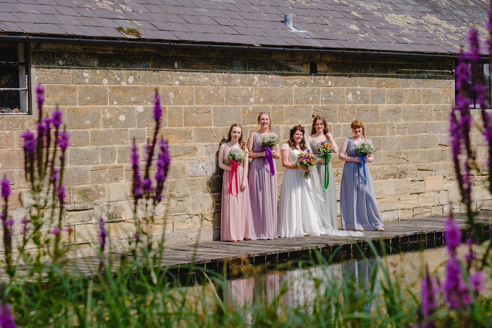 Bridesmaids in different coloured pastel dresses