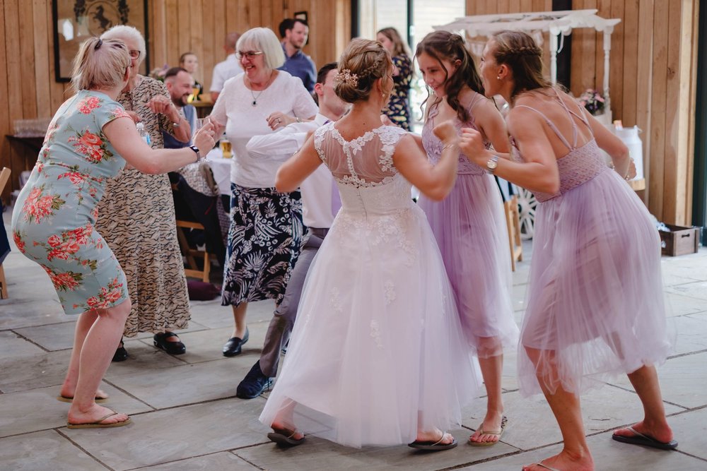 Bridesmaids in lilac knee length floaty dresses