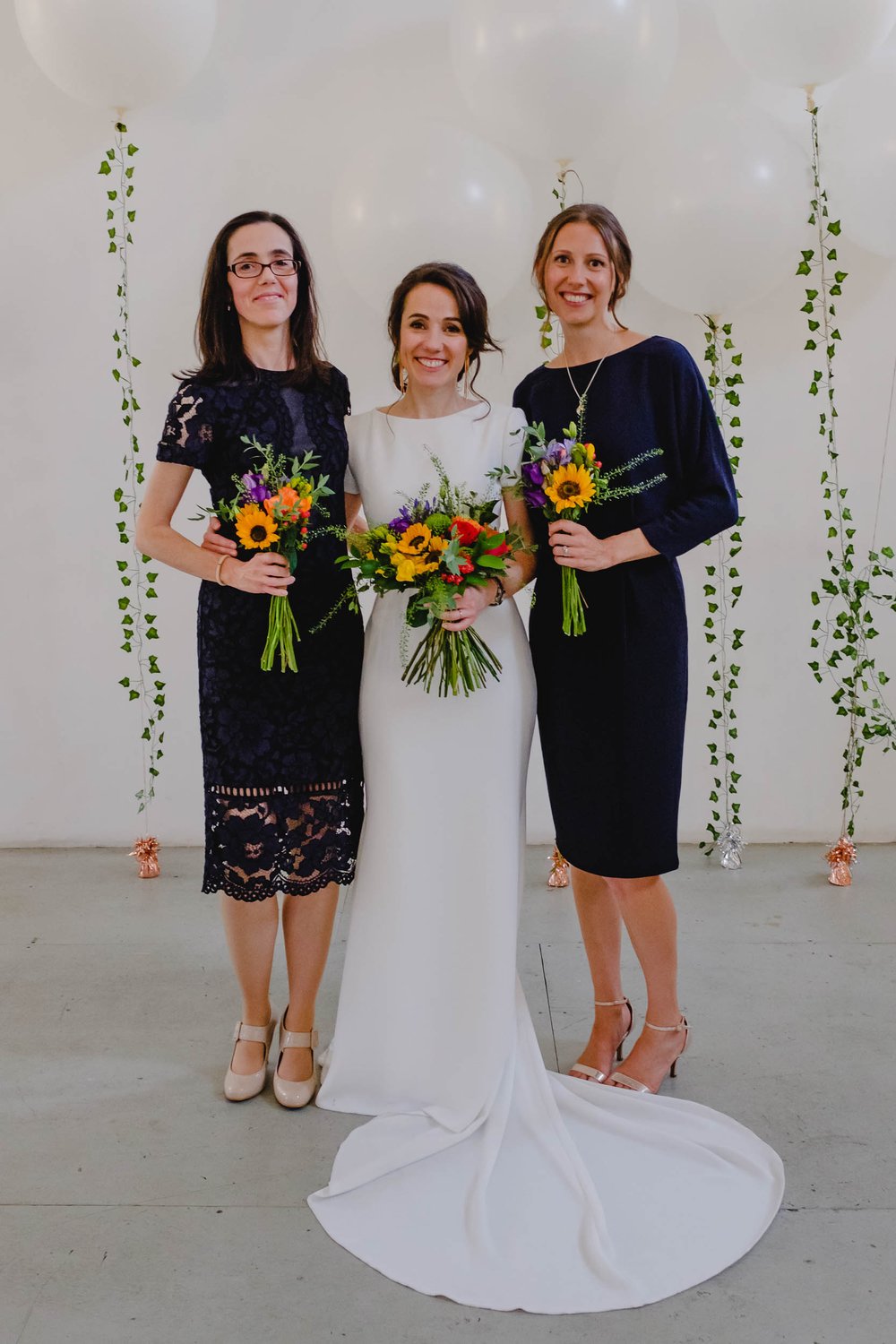 Bridesmaids in black knee length lace dresses