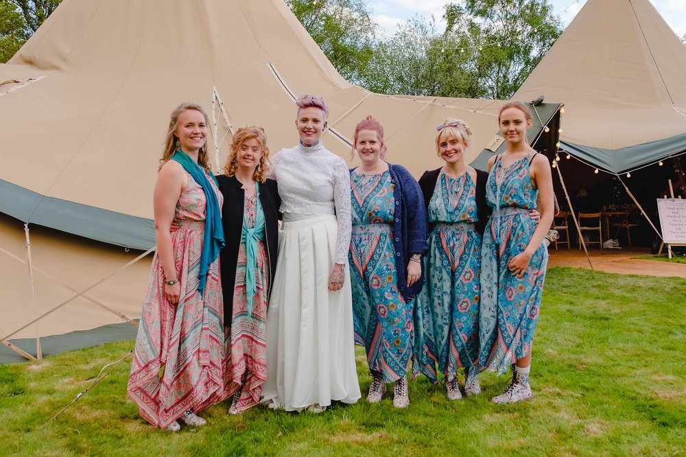 Bridesmaids in printed scarf style dresses and DMs