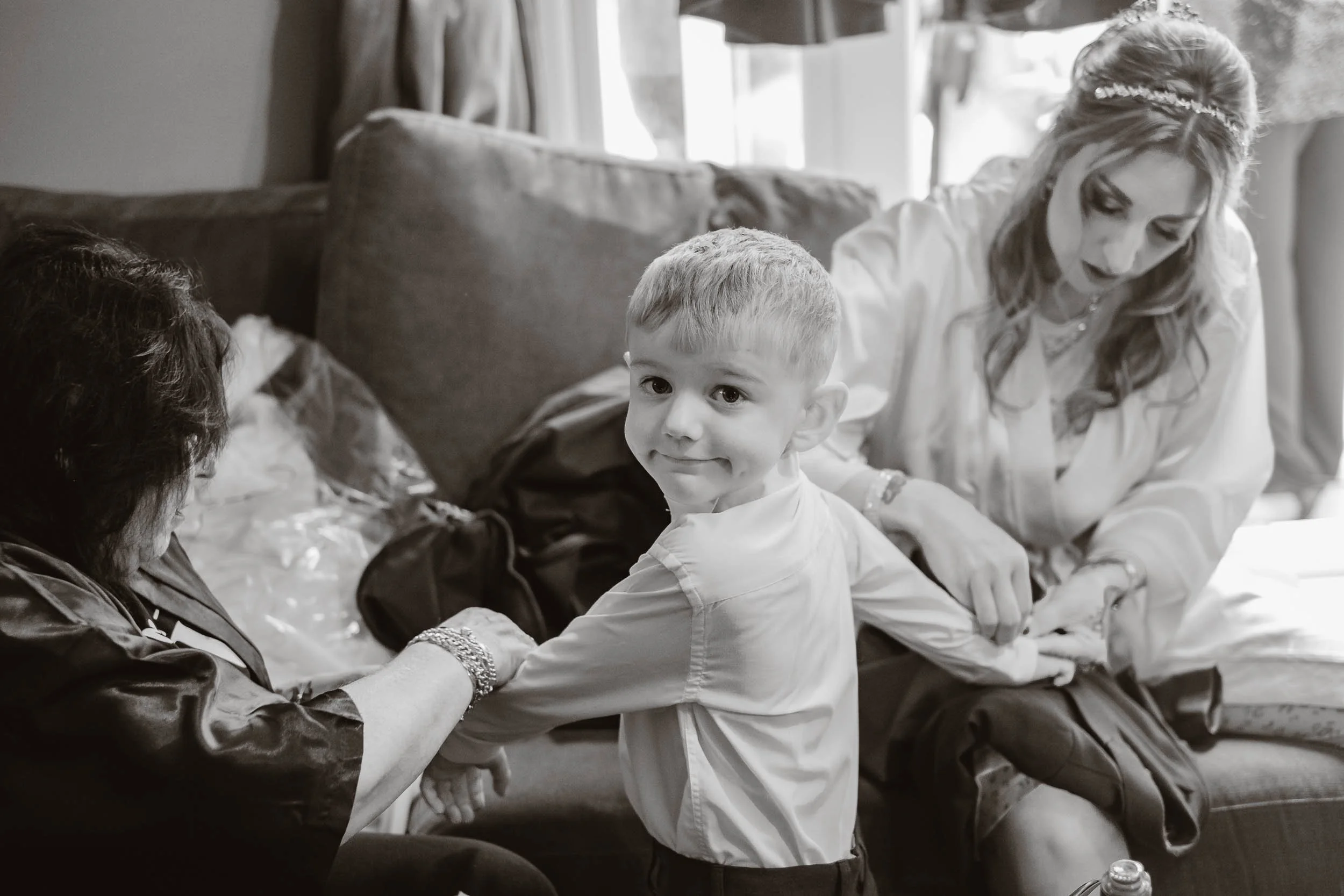 Pageboy being dressed by mum and granny