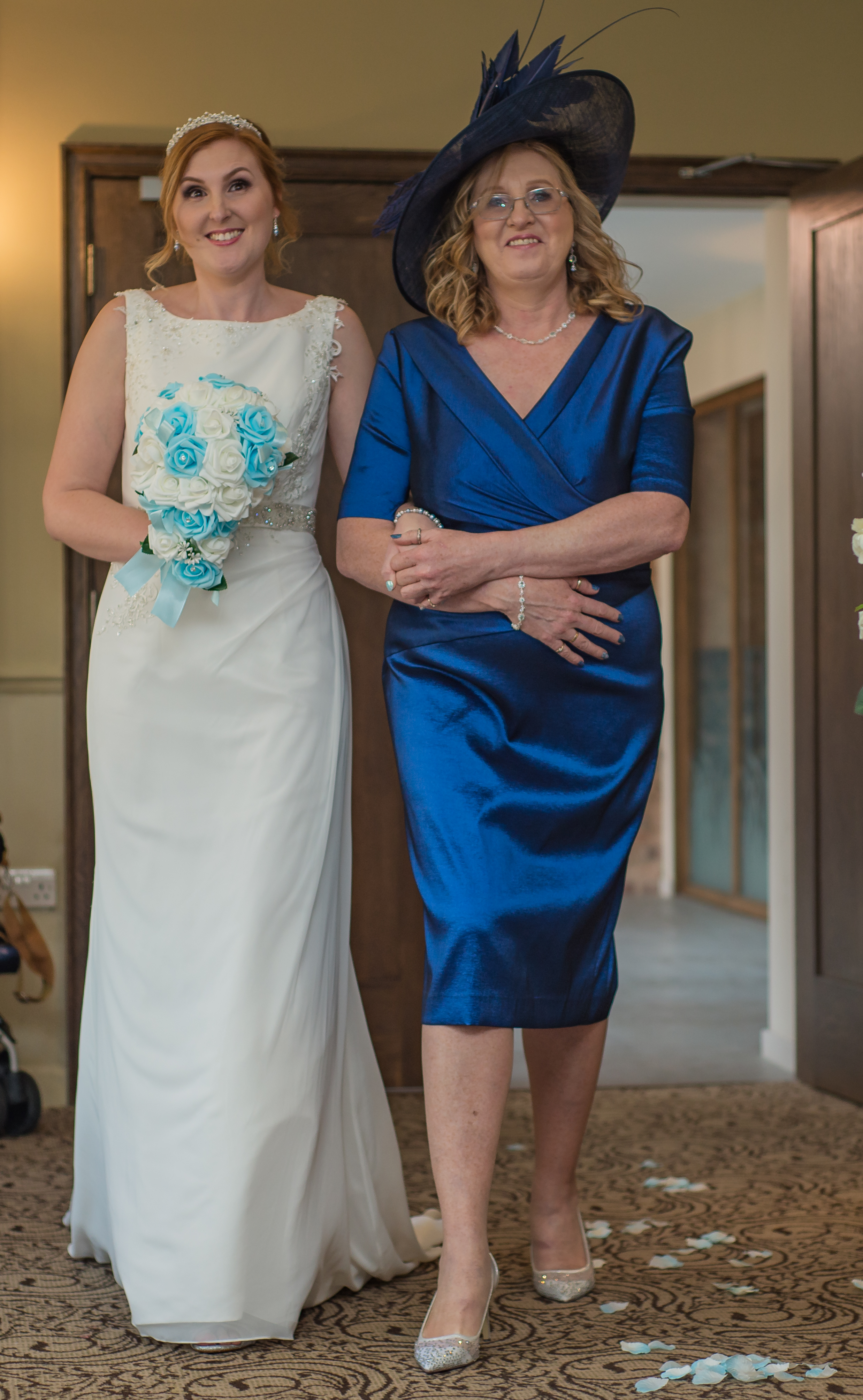 wedding photography and wedding videography, the bride walks down the aisle accompanied by her mother