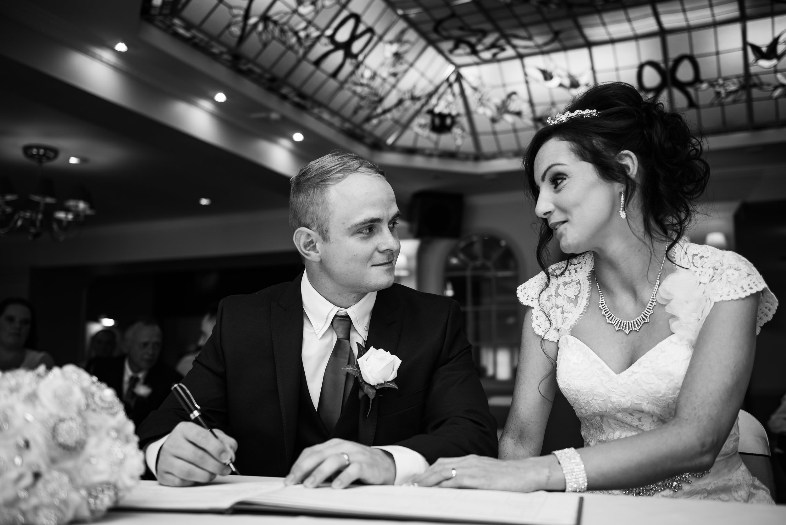 black and white wedding photography signing the register