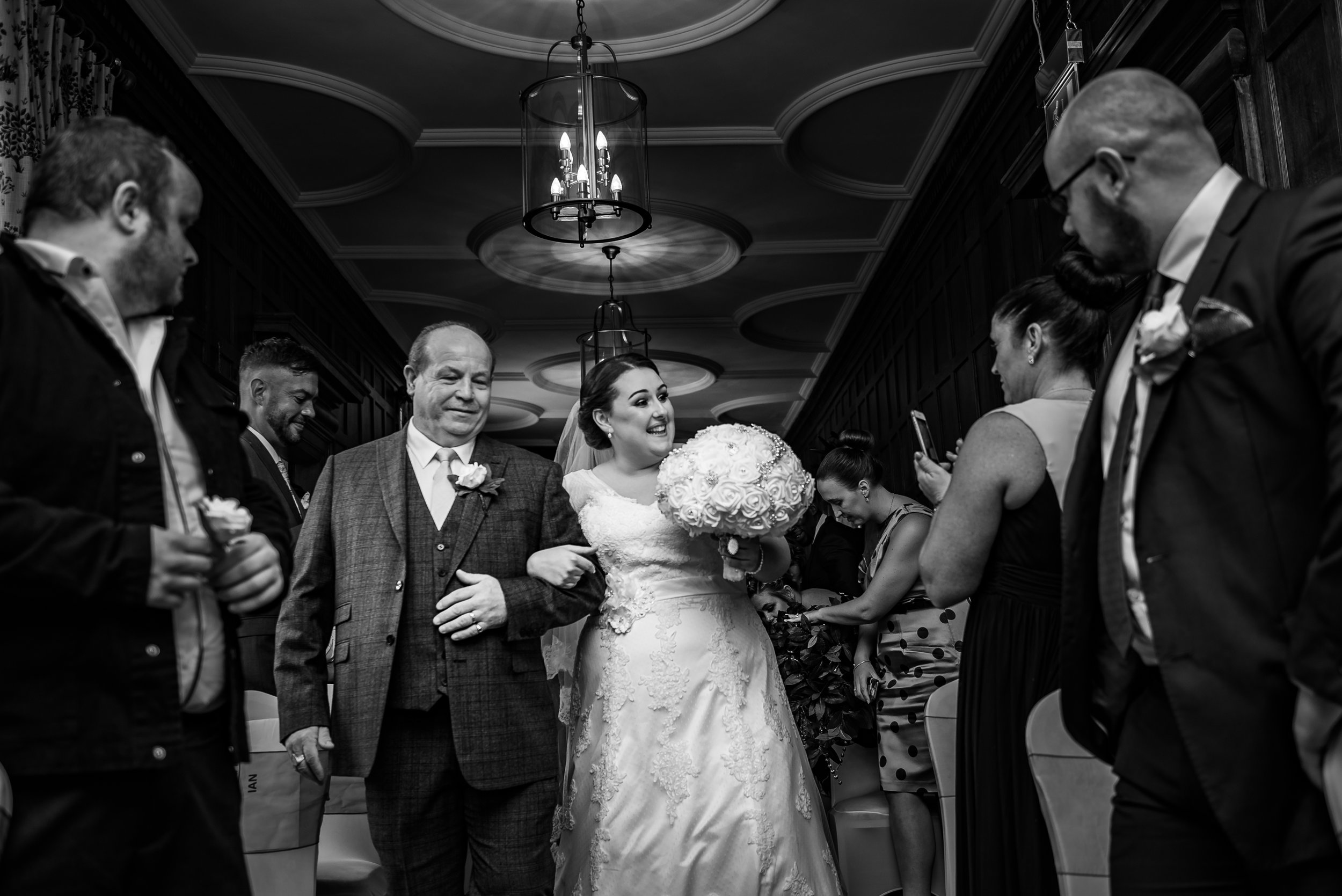 black and white wedding photography groom here comes the bride