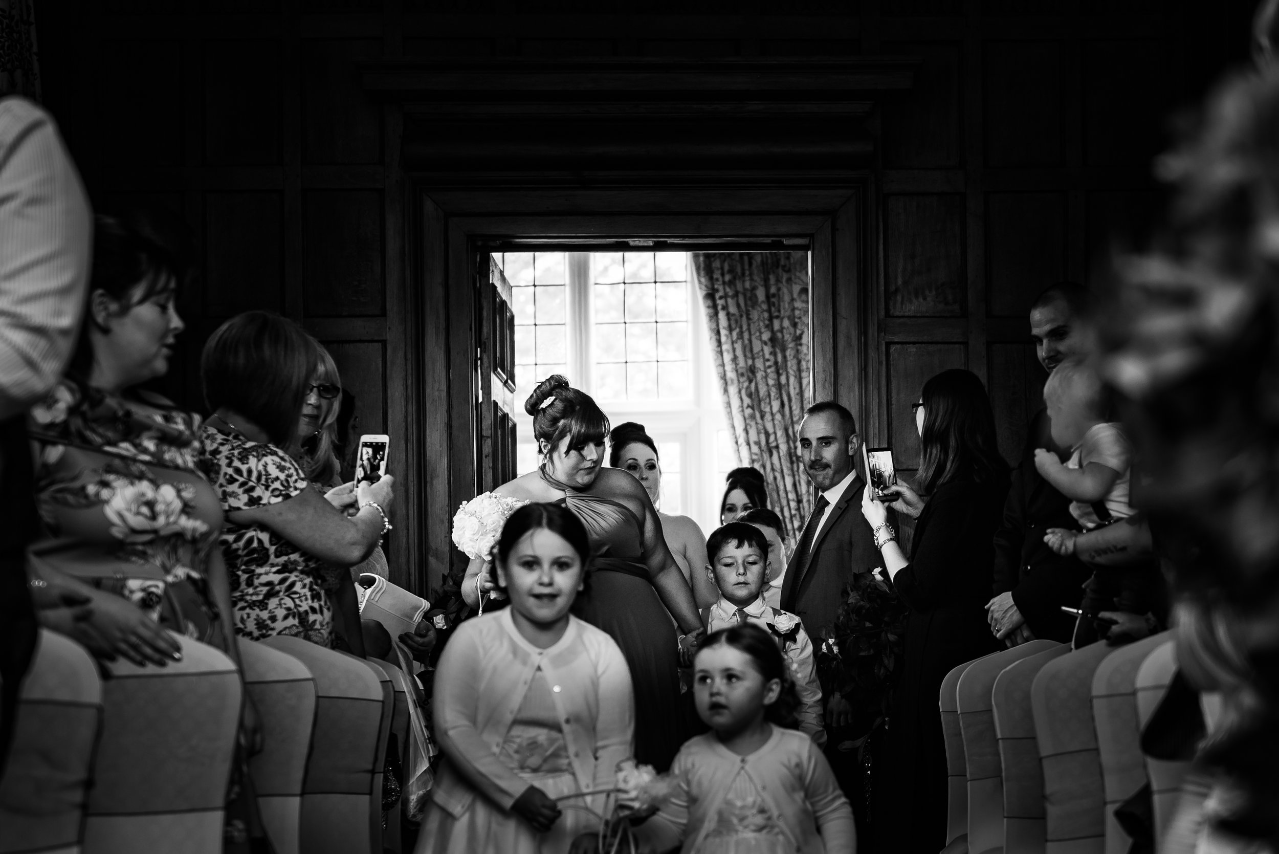 black and white wedding photography groom here comes the bridesmaids