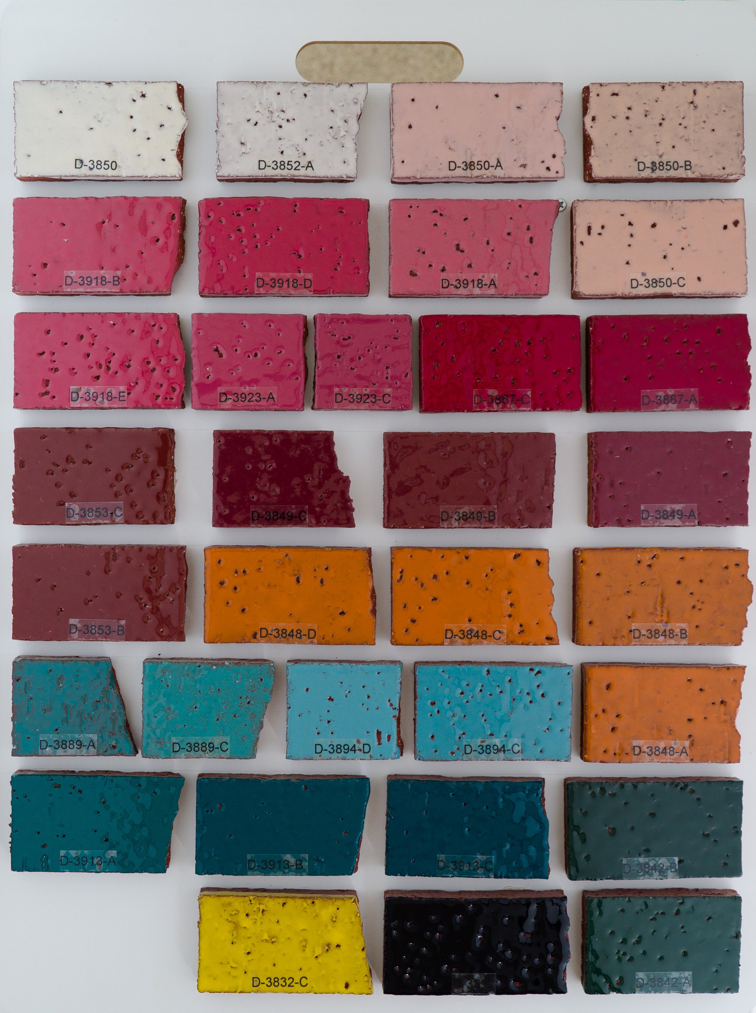 Sample display board 10 showing Gloss Opaque Glazes fired on Red Brick body at Cone 05. Codes ranges include D-3850 to D-3842-A.