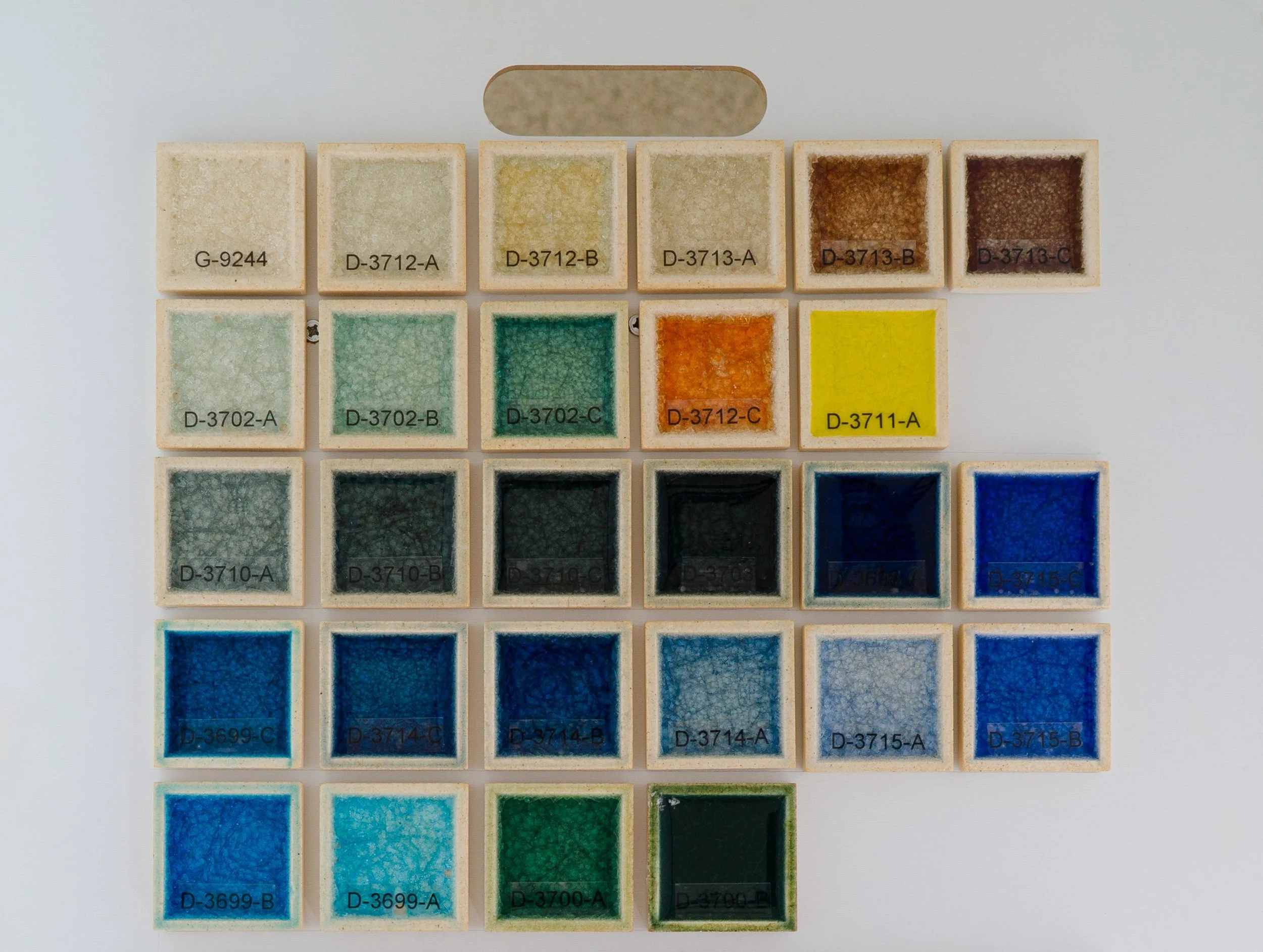 Sample display board showing Glass Glazes fired at Cone 05. Codes ranges include G-9244 to D-3700-B.