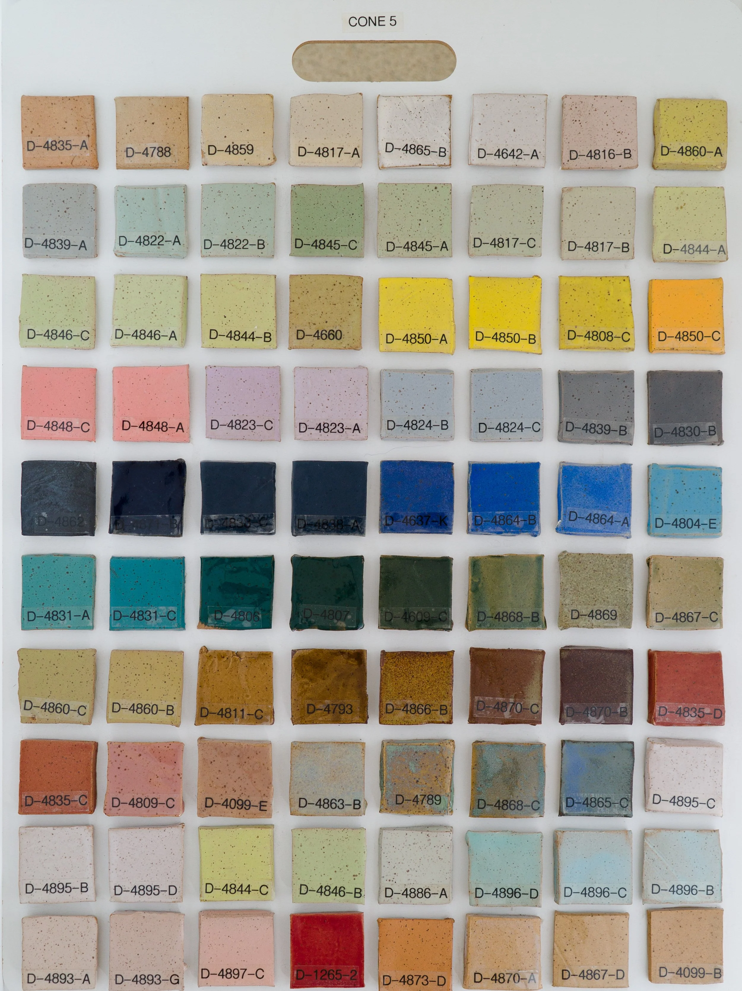 Sample tile board showing Cone 5 glazes on Speckled Buff clay body (Codes D-4835-A to D-4099-B).