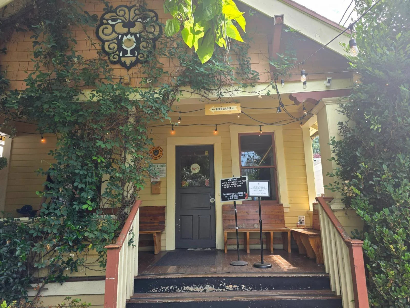 A yellow northwest style house that's been covered into a brewery