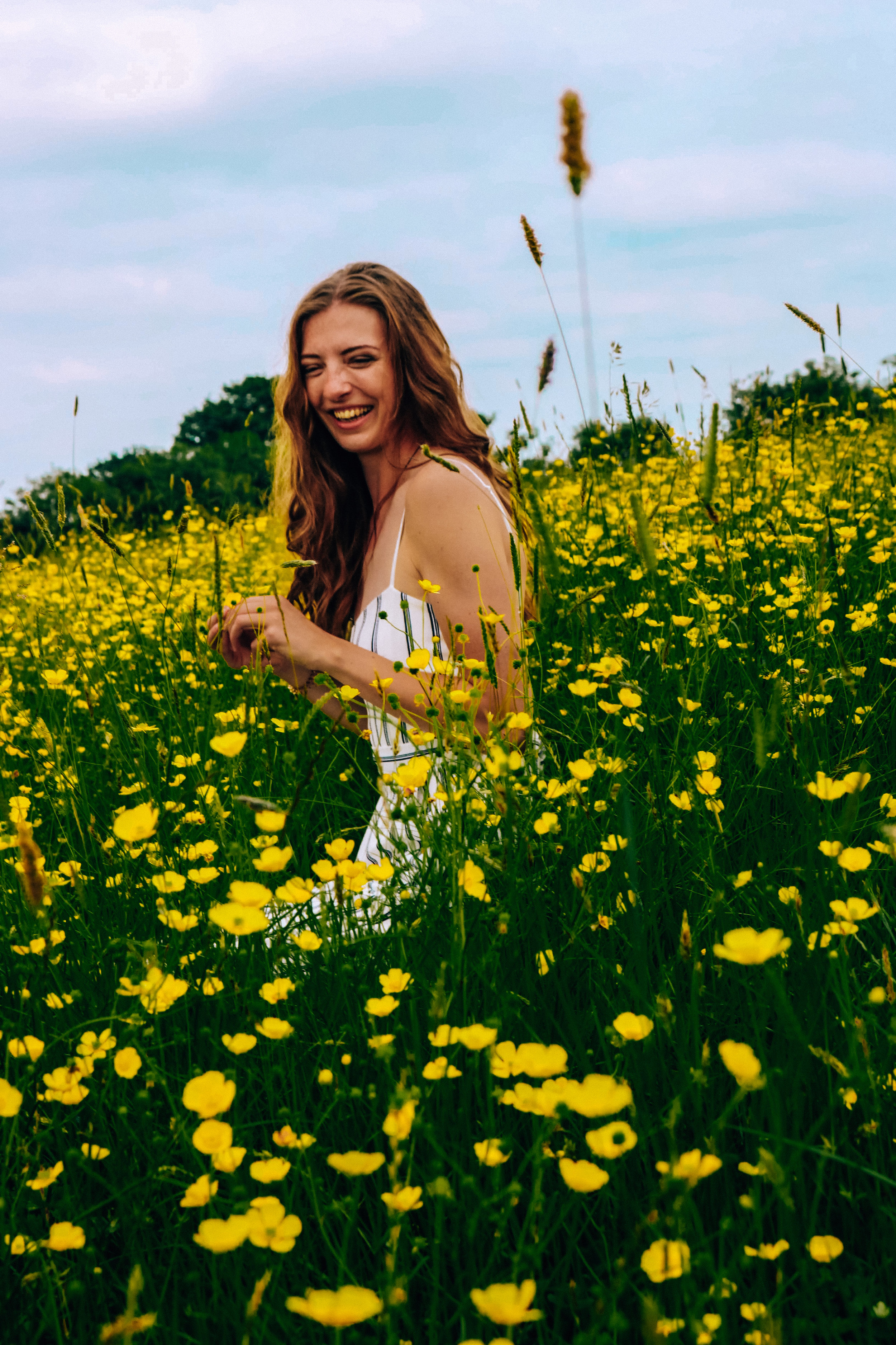 Sitting in a field of buttercup flowers