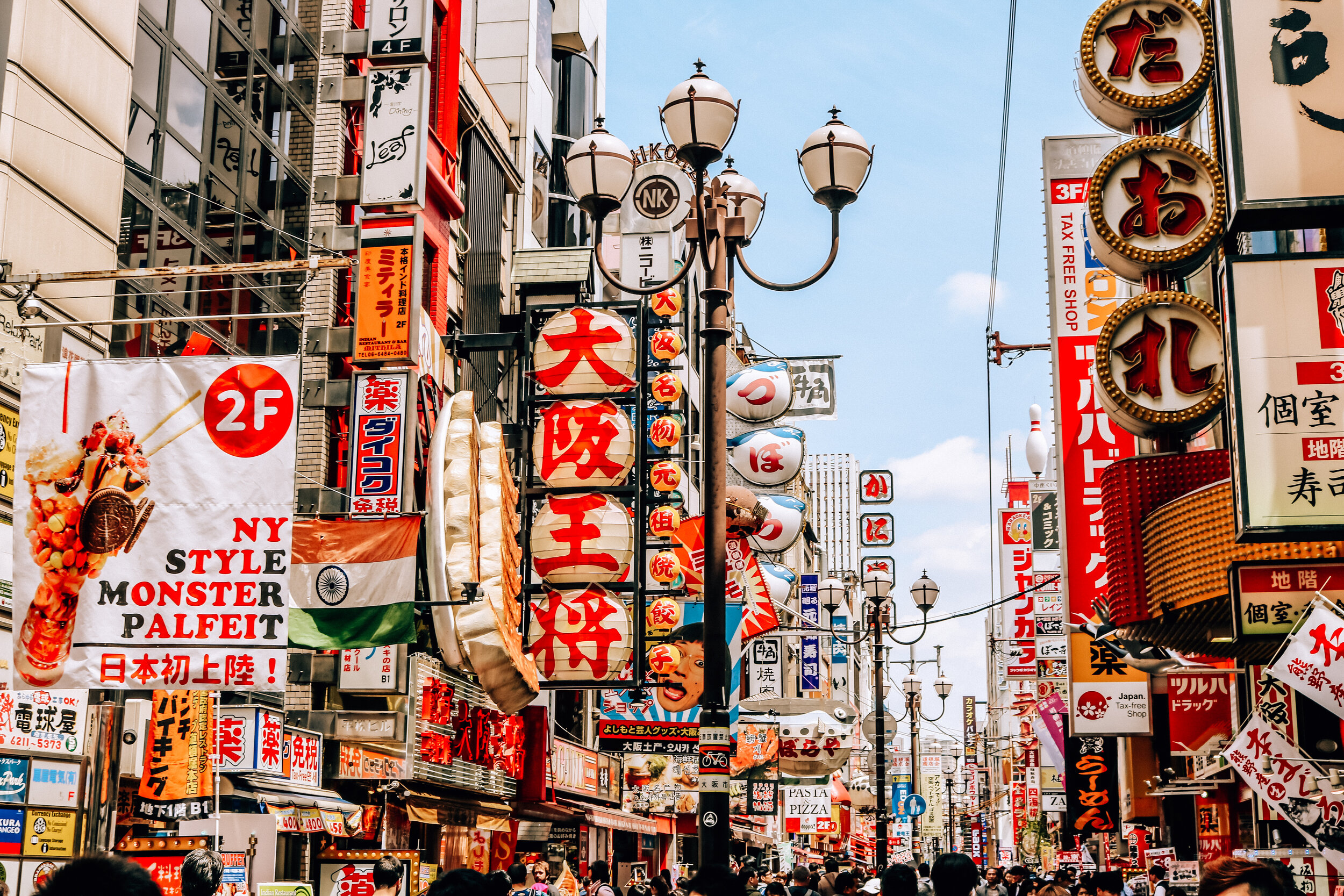 Many colorful signs on buildings lining the busy streets of Japan