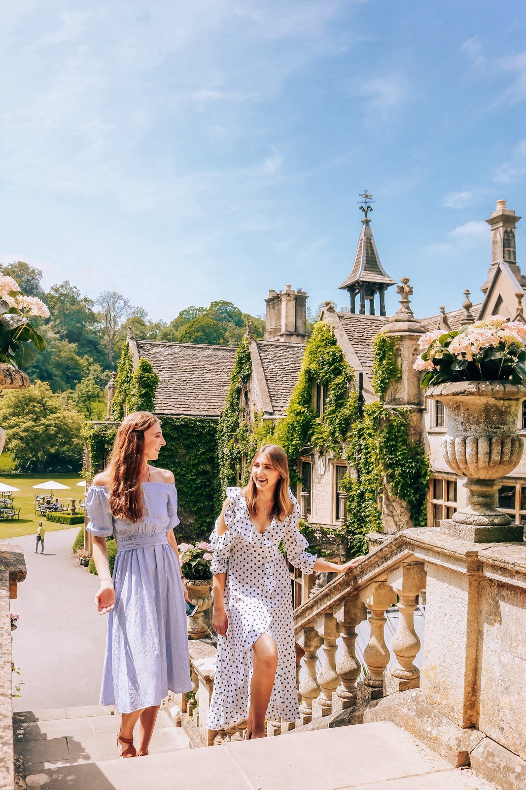 two girls walking up the Manor House steps in Castle Combe