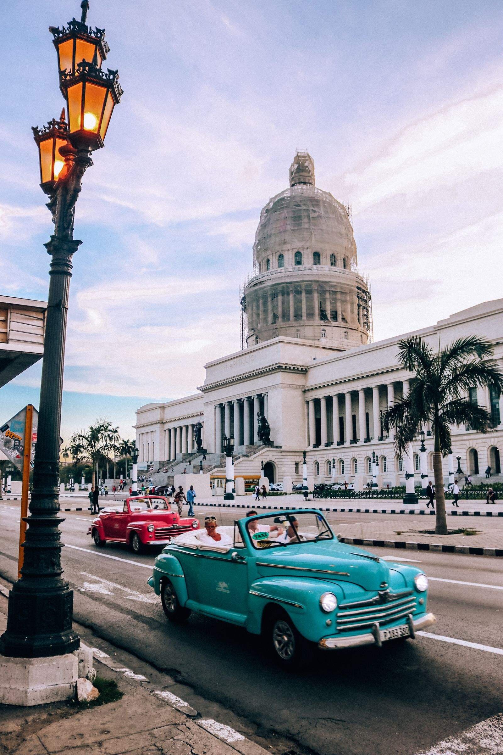 classic Cuban cars in front of El Capitolio building