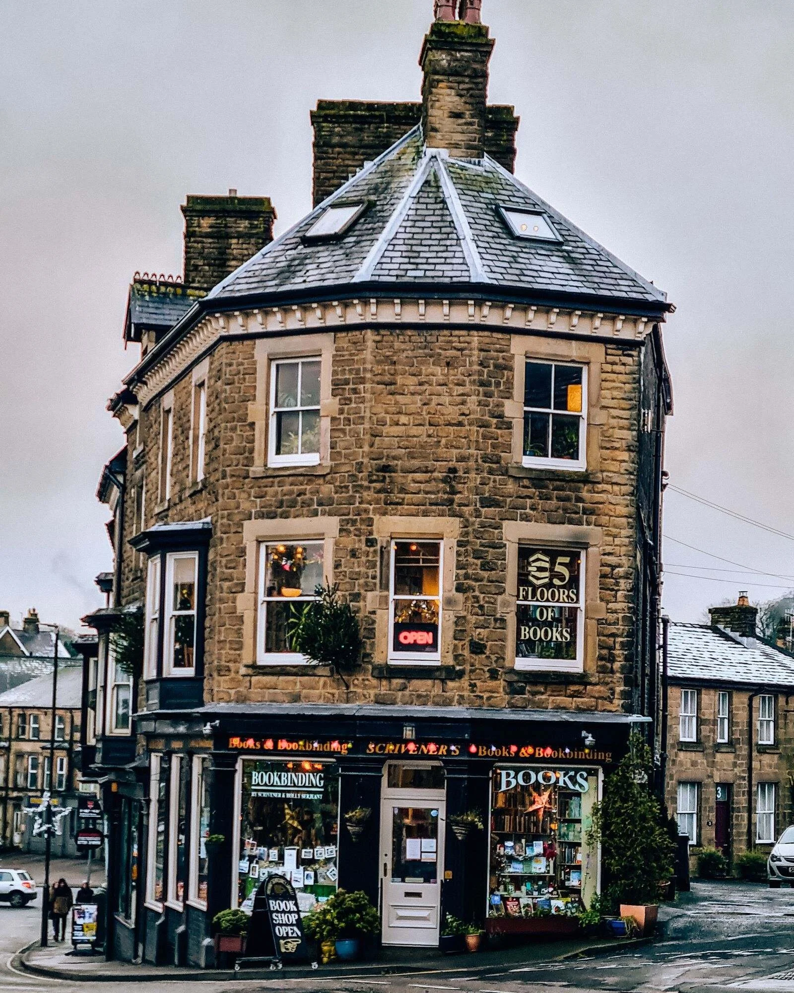 An old stone building housing a bookstore which seems to be leaning to the right slightly