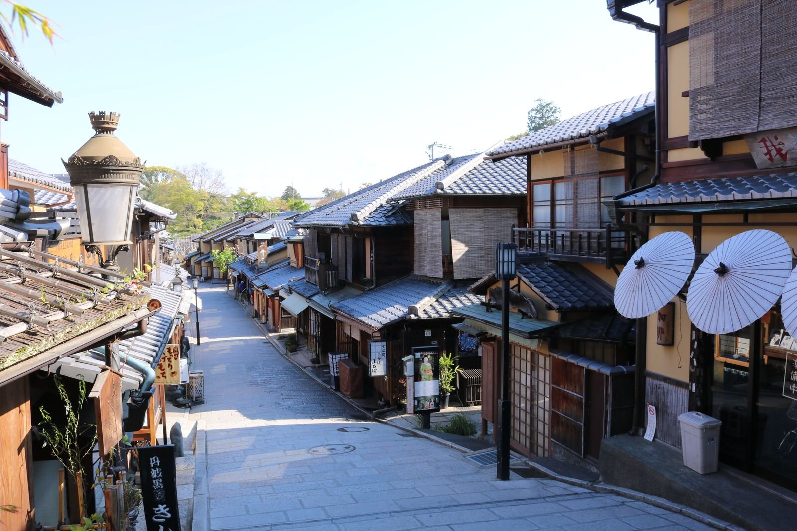 An empty street with many wooden traditional Japanese buildings in Gion historic district