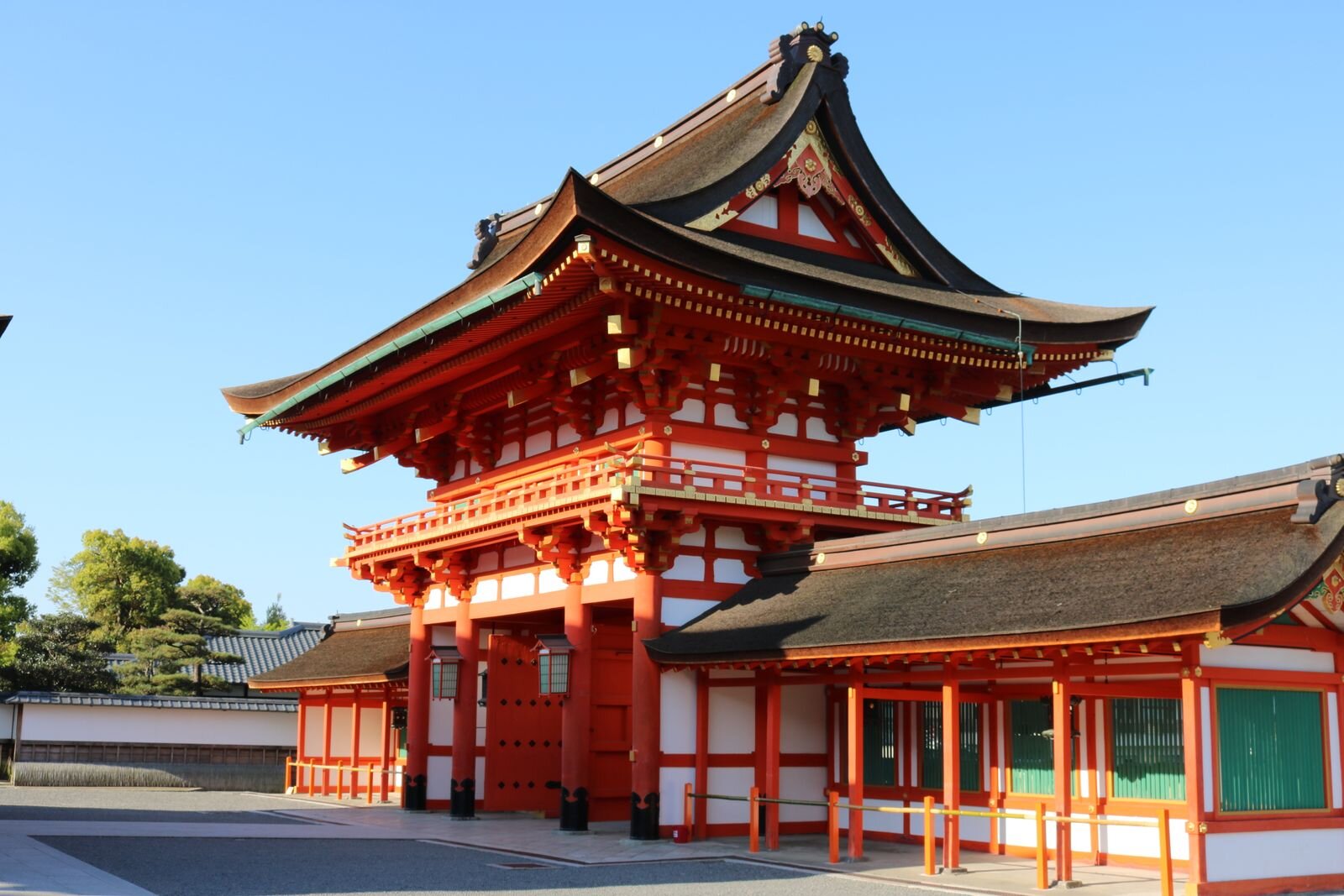 The large orange gate at entrance of a shrine in Kyoto