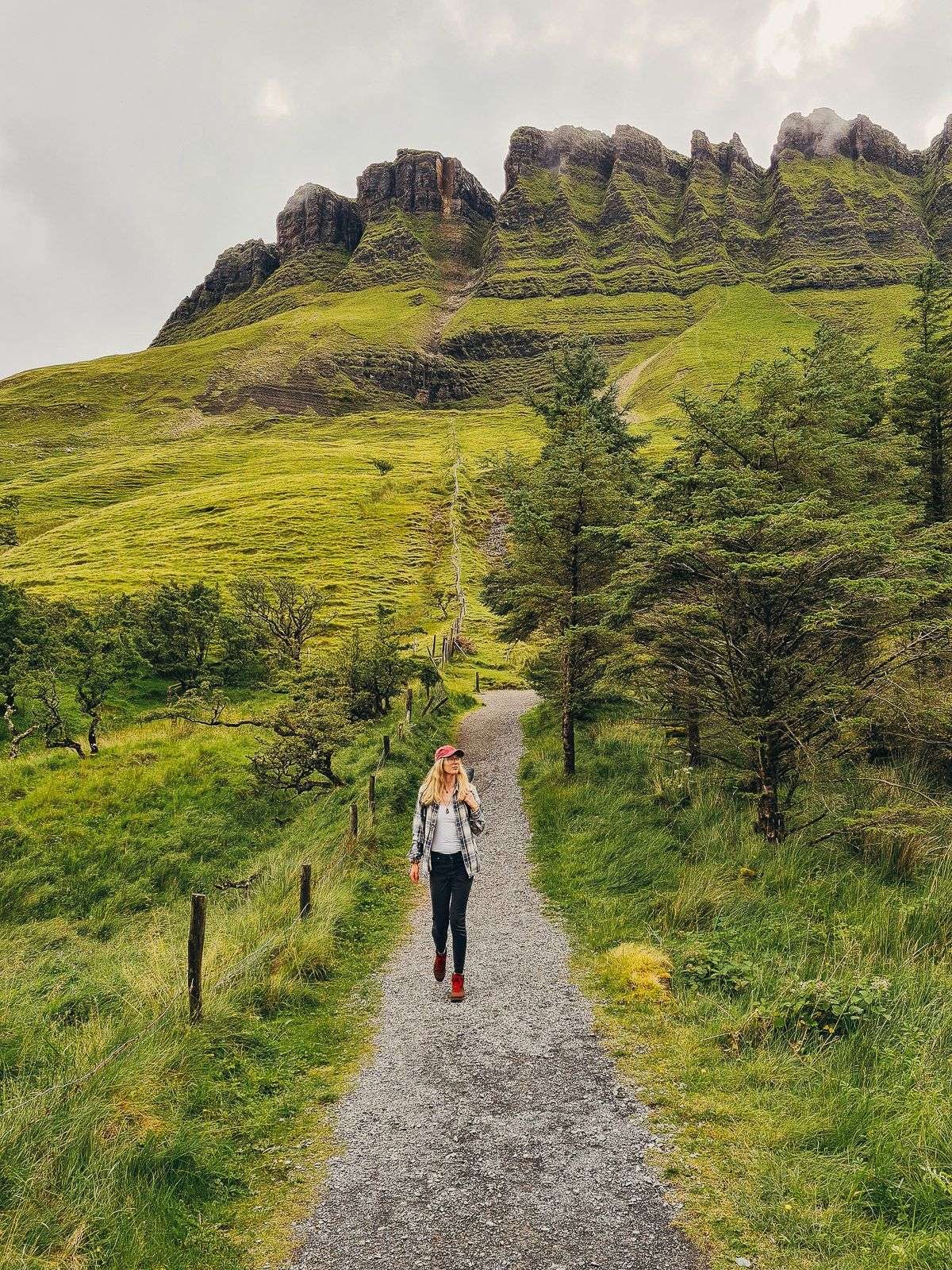 girl walking along path with misty mountain the the background