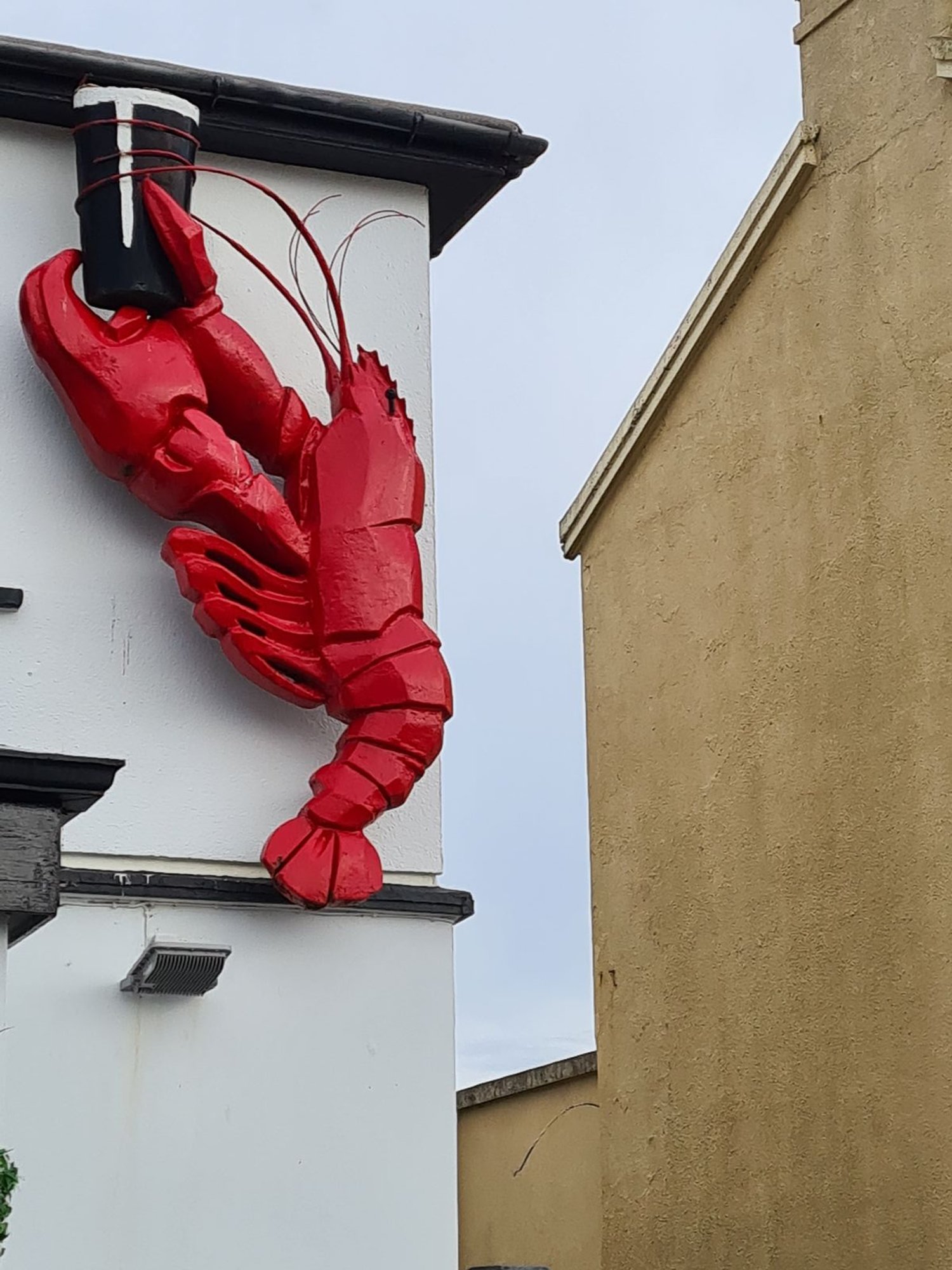  Large outdoor fixture of a lobster holding a pint of beer 