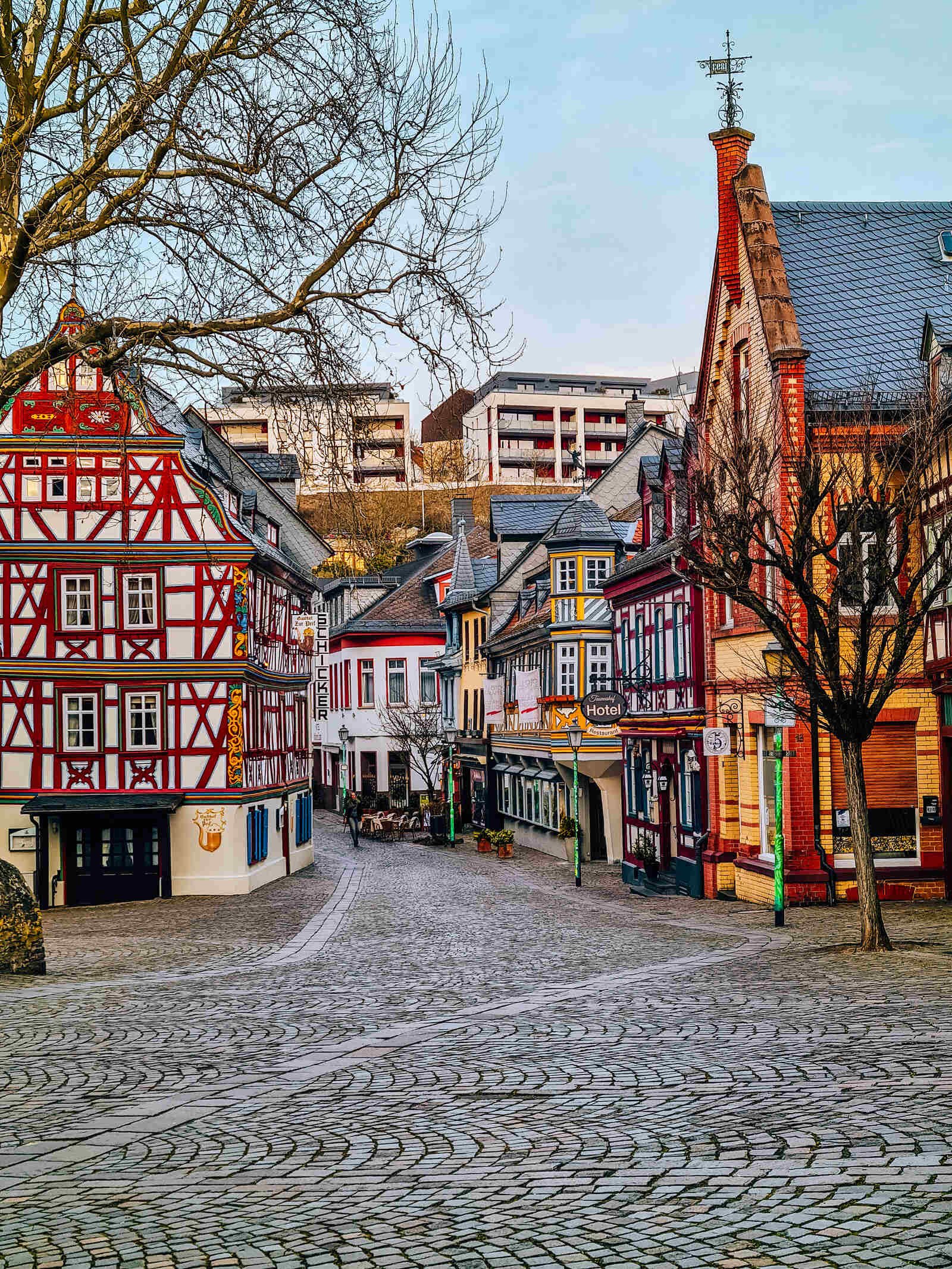  A large cobbled streets with old traditional German buildings lining each side of the street 