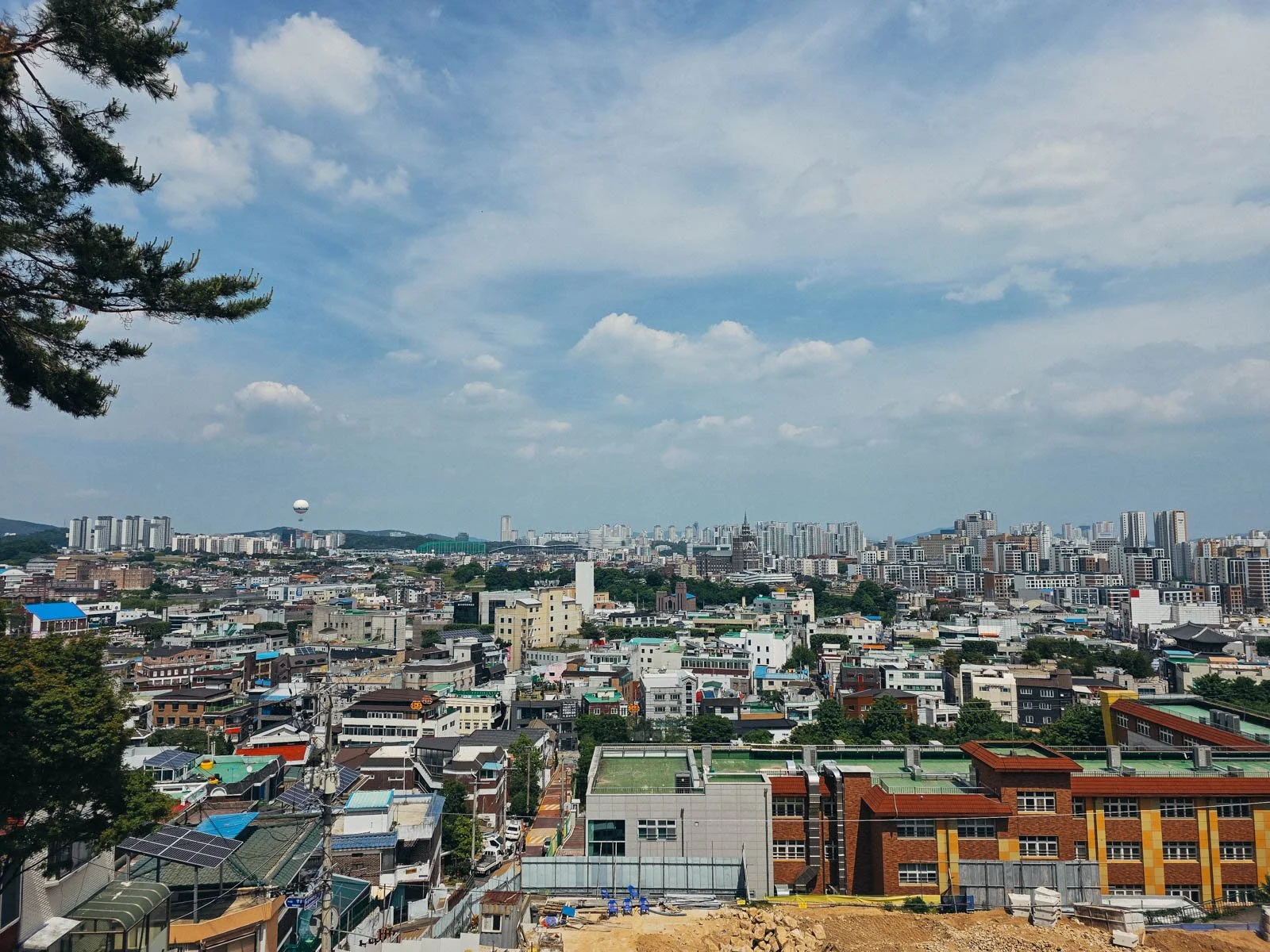 A high up view of a city with many buildings stretching into the distance