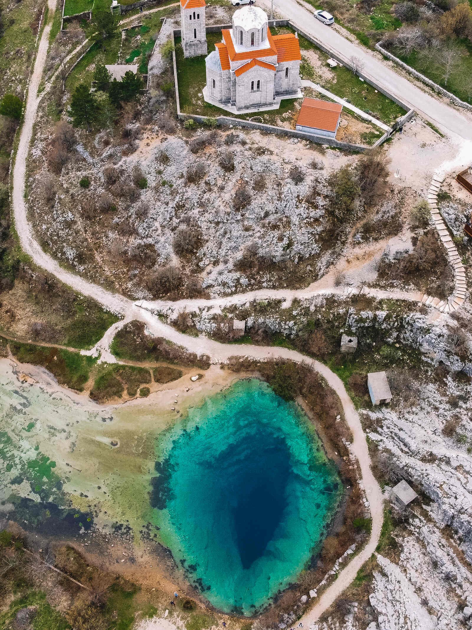 aerial view of cetina river spring with a church on the hill