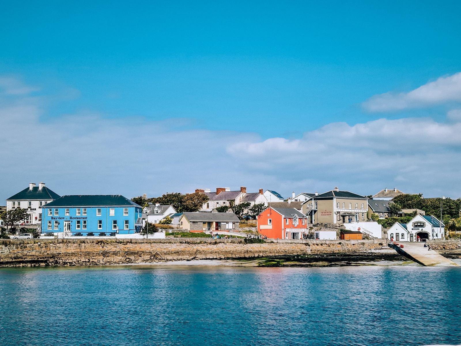 view from the water of the colourful houses on Inishmore island in the Aran Islands