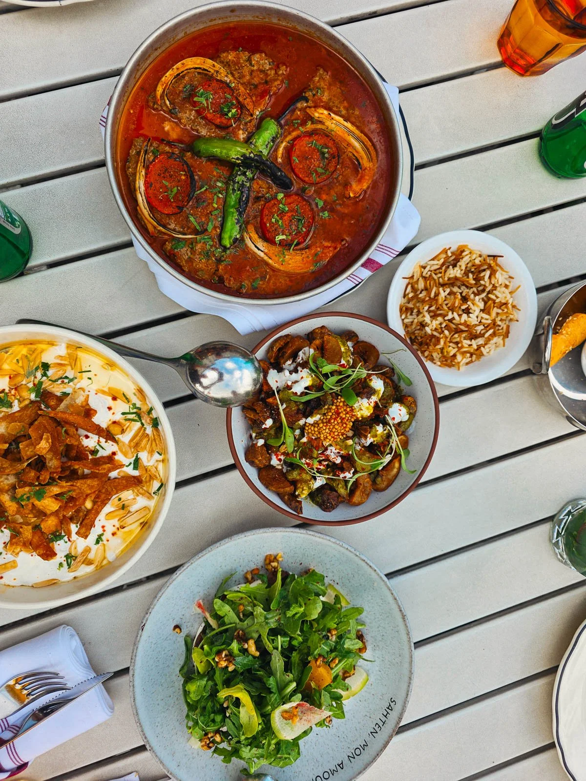 Five dishes of Middle Eastern food on a table at a restaurant