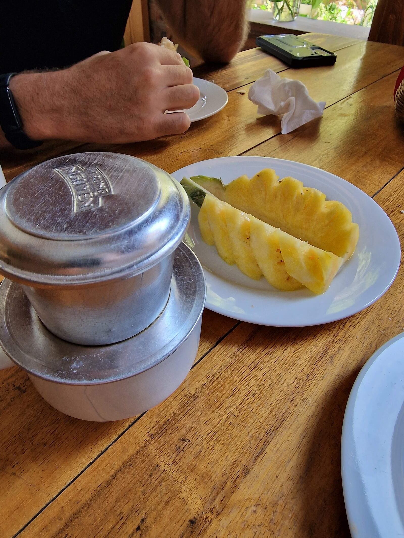 a traditional Vietnamese coffee drip tin on top of a cup