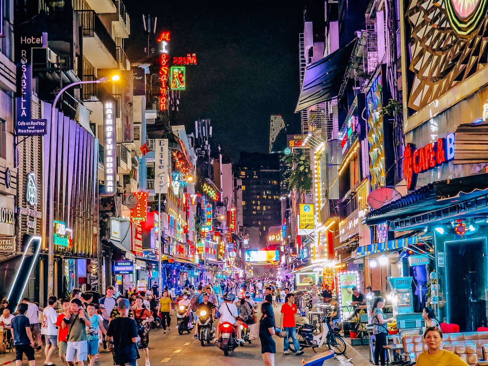 the colourful bui vien street lit up at night in Ho Chi Minh City, busy with people
