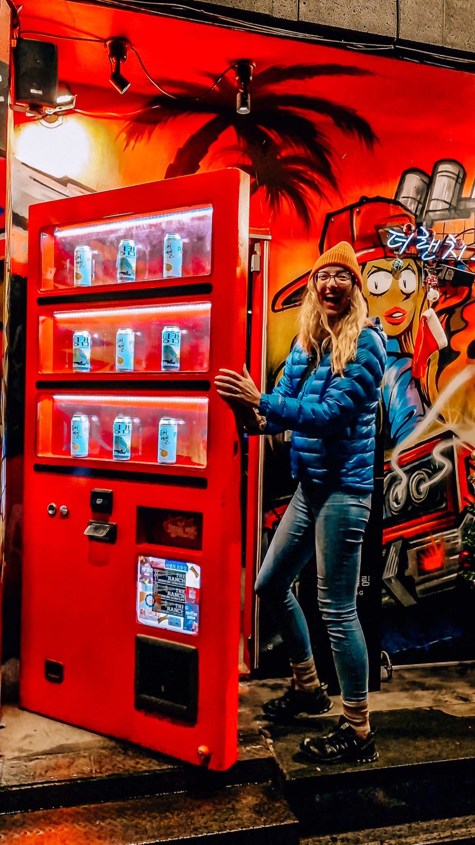 Helena walking into a doorway hidden behind a red vending machine