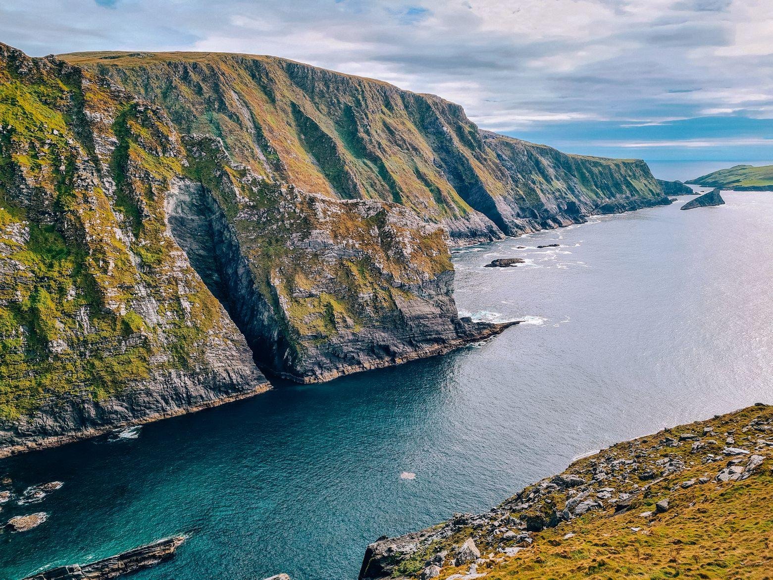 rugged green and rocky cliffs on the edge of the atlantic