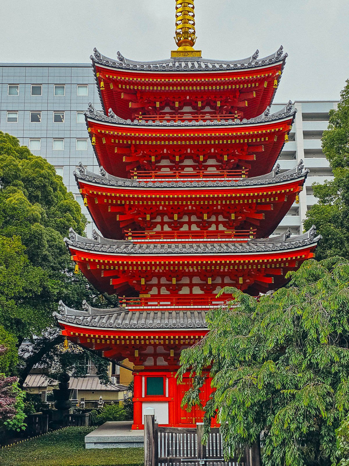 a bright red orange 5-tier pagoda at a temple in Fukuoka