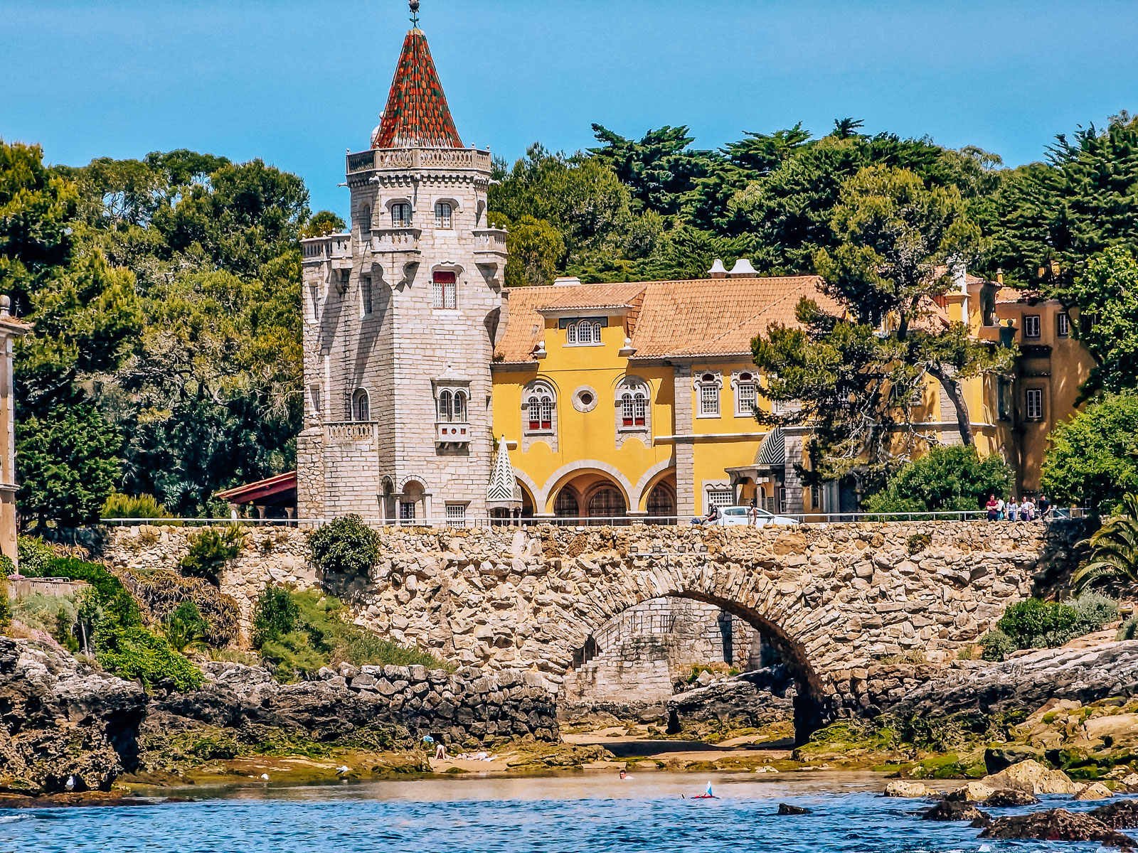 A yellow Portuguese style villa with a turret