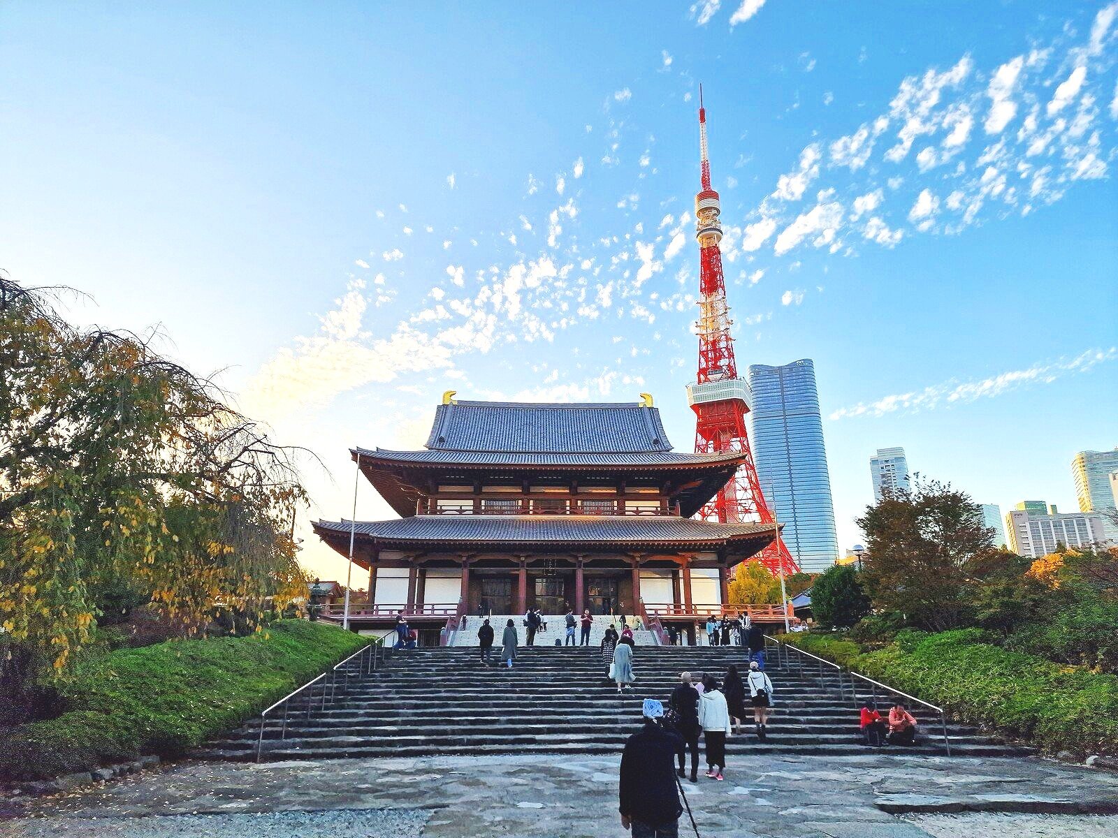 a wooden japanese temple with Tokyo Tower orange behind it